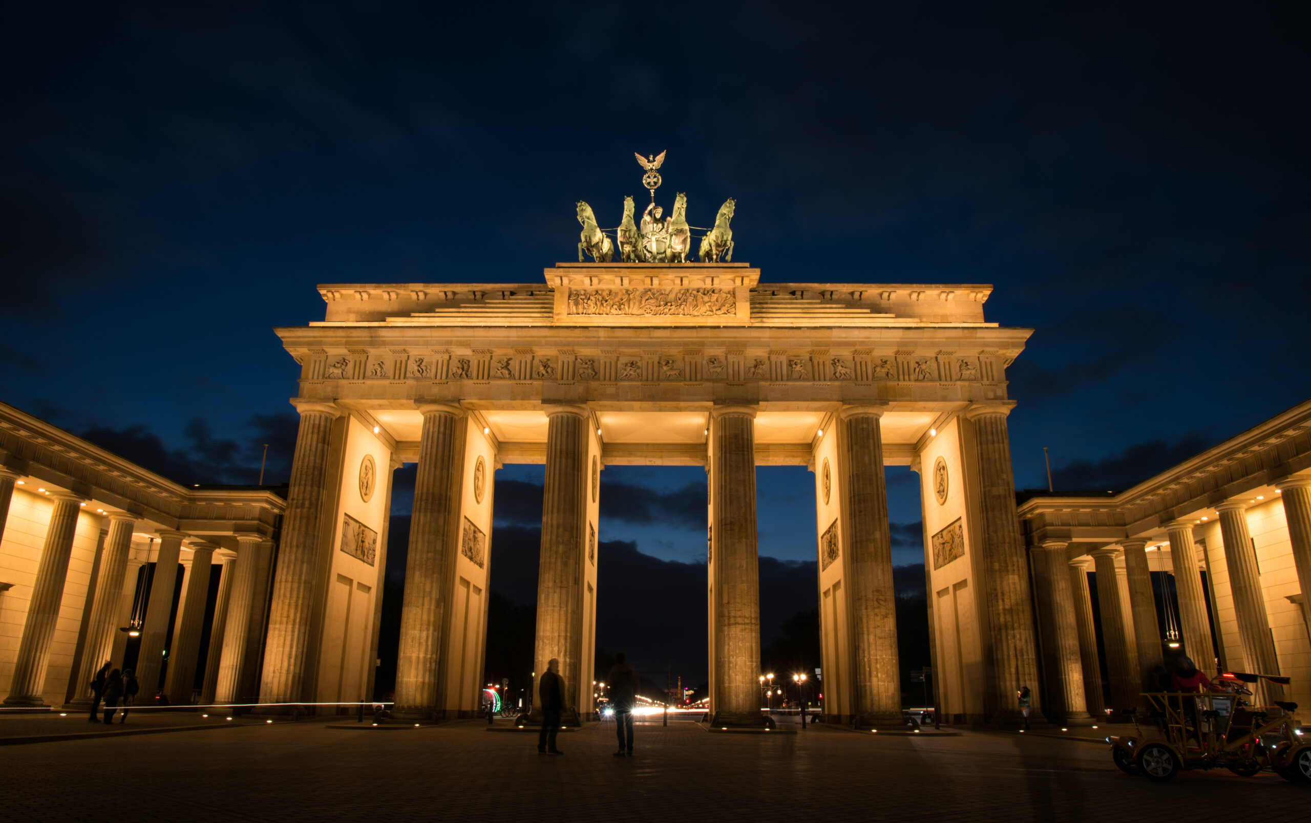 Berlin, Germany - January 16, 2016:  Illuminated famous neoclassical triumphal arch of Brandenburg Gate one of the best-known landmarks of Germany in Berlin  just after sunset .