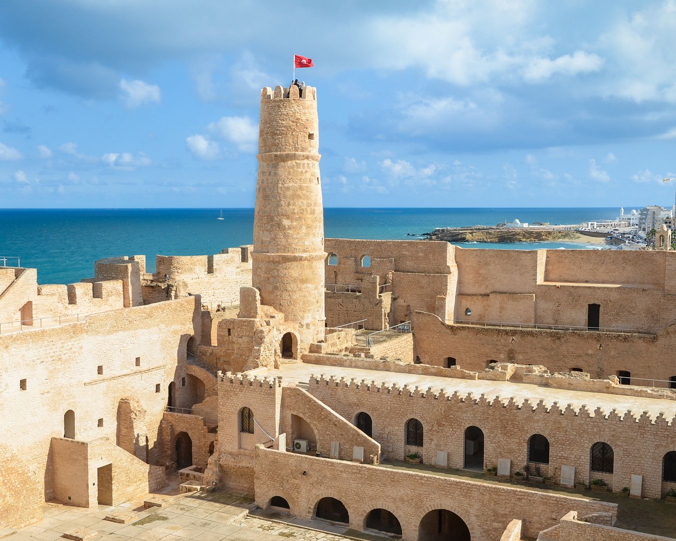 Vista panorâmica da fortaleza islâmica de Ribat de Monastir com torre de observação e o Mar Mediterrâneo ao fundo, na Tunísia